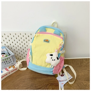 Detail of colorful children's backpack with plush star pendant and multi-pocket design