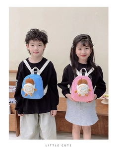 Detailed view of mini plush backpacks in blue and pink with cute face designs for kids