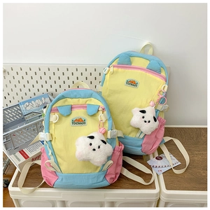 Detailed comparison of two yellow macaron backpacks with plush star charms and brand logo