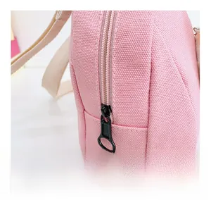 Close-up of durable smooth zipper and pink canvas texture on cute children's backpack