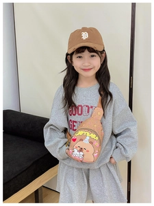 Adjustable canvas crossbody bag with cute cartoon bear print shown on child model
