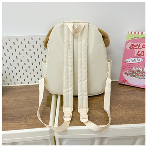 Detail of adjustable straps and side pocket on cute cream backpack with plush ears