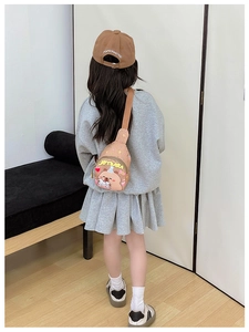Rear view of a child wearing a brown Capybara cartoon crossbody bag with adjustable strap