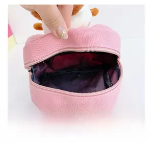 Detail view of pink canvas toddler backpack showing internal storage and zipper opening