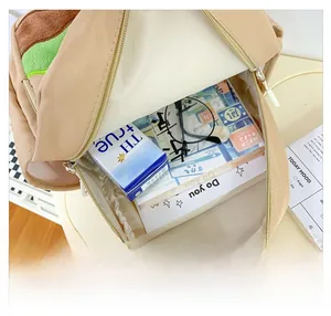 Top view showing internal capacity of the cute beige student backpack with school supplies