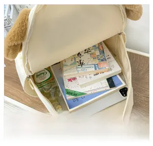 Interior view of the cute dog backpack showing space for a tablet, books, and a bottle