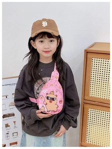 Detailed view of pink kids chest bag with cartoon capybara print and adjustable strap