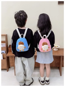 Detail of pink and blue canvas mini backpacks with cute plush toast doll for kids