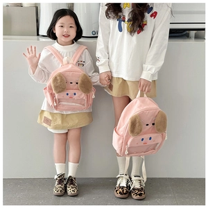 Detail of cute pink puppy toddler backpack with fluffy ears and a clear zip pocket