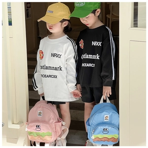 Outdoor shot of kids wearing cartoon burger backpacks and sporty striped long-sleeve hoodies