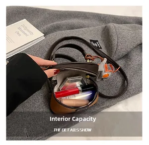 Internal view of a cylinder cross-body bag showing storage for makeup and lipstick