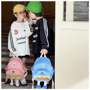 Kids cute burger shaped backpacks in pink and blue colors worn by children outdoors