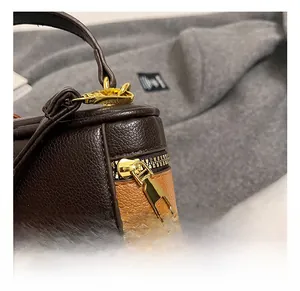Detail of premium golden metal zipper and buckle on a lychee pattern leather bag