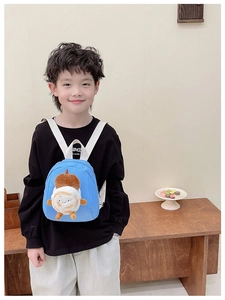 Detail of a sky blue toddler backpack with cute plush cartoon toast decor on straps