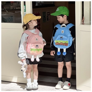 Detail view of cute cartoon burger backpacks in pink and blue for kids
