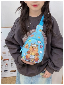Detail of blue kids chest bag featuring a cute cartoon bear riding a motorcycle print