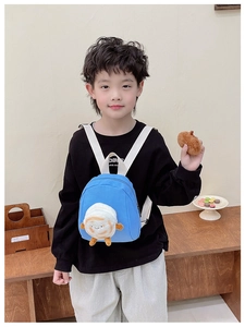 Blue mini toddler backpack with 3D cartoon toast doll and wide white straps shown on child