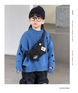 Close-up of kids black chest bag with white fashion print and decorative lanyards