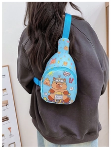 Detail of blue kids chest bag featuring a cute capybara print and adjustable strap