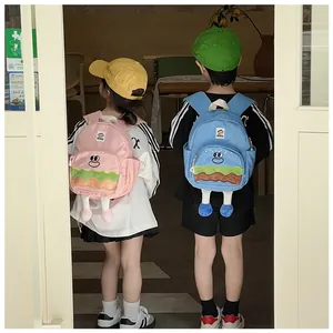 Kids wearing cute cartoon hamburger backpacks in pink and blue colors with 3D plush feet