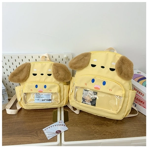 Detail of yellow toddler backpacks featuring plush ears and a clear PVC card window