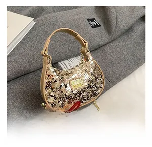 Macro detail of champagne gold sequin texture on mini handbag with leather handle