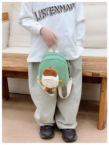 Mini green canvas backpack for kids featuring a cute chestnut plush charm and white straps
