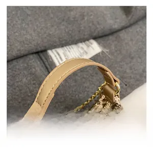 Detail of glitter sequins mini handbag with leather handle and golden metal ring hardware