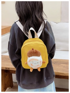 Toddler backpack with yellow plush acorn character shown on a child model's back