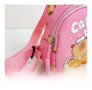 Detailed close-up of smooth pink zipper and capybara print on nylon kids bag