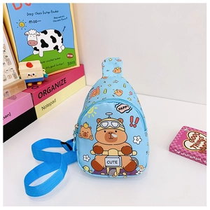 Detailed view of sky blue kids sling bag featuring a cute cartoon bear riding a motorcycle