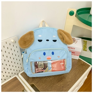 Detail of light blue puppy backpack featuring soft ears and a clear front window pocket