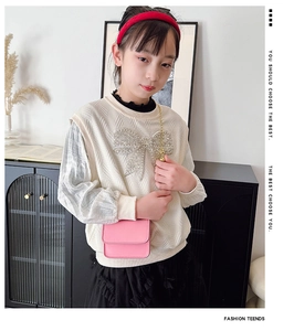 Pink mini crossbody bag for kids with gold chain strap and magnetic flap closure