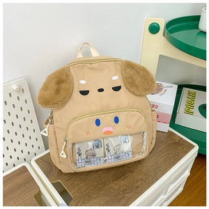 Close-up of khaki canvas dog backpack featuring brown plush ears and a clear front pocket