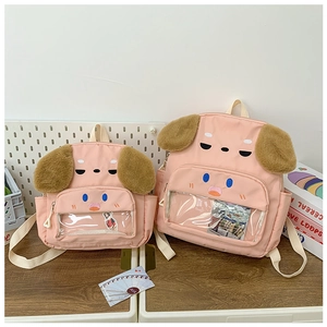 Detail of pink dog backpacks in two sizes with plush ears and transparent front pockets