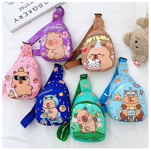 Flat lay of colorful children's Capybara crossbody bags in purple, brown, and pink