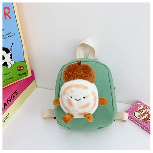 Detail showing green canvas material and plush cartoon squirrel on toddler backpack