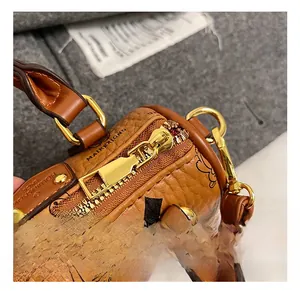 Detail of golden metal zipper and bear pattern on brown pebbled leather bag