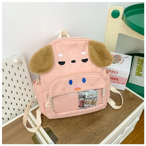 Pink dog-shaped backpack for kids featuring fluffy ears and a clear front storage window