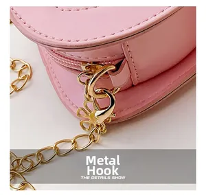 Detailansicht goldener Blütenhaken und Metallkette an der rosa Leder-Umhängetasche