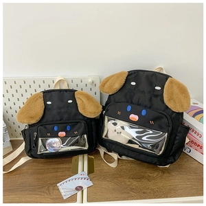 Detail of cartoon dog backpack with transparent PVC window for pins and plush ear accents