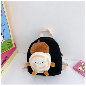 Detail of a mini black canvas backpack featuring a cute plush doll and cream fabric straps