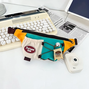 Detailed macro view of vibrant color-block kids chest bag with adjustable strap and logo tag