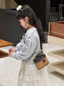 Side view of a girl wearing a stylish brown and khaki lychee pattern mini box handbag