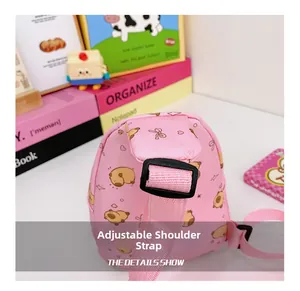 Detail view of the adjustable pink shoulder strap and secure buckle on a cartoon kid bag
