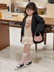 Fashionable girls outfit with a black blazer and a pink sequin mini handbag