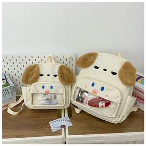 Detail of cute cream dog backpacks with plush ears and transparent PVC display windows