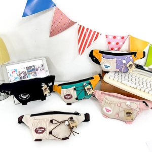 Detailed view of colorful multi-pocket crossbody waist bags for kids in diverse color schemes
