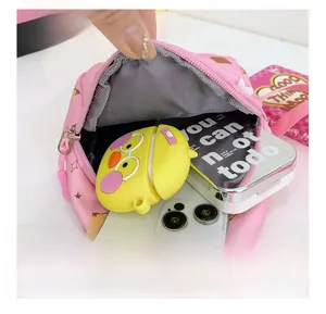 Internal view of the pink cartoon crossbody bag showing large storage capacity for accessories