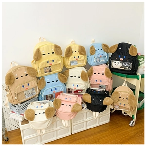 Detail of adorable puppy backpacks showing plush ears and clear front pocket for kids
